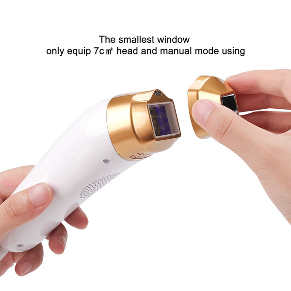 Handheld device with gold and white components, held by a person's hand on a white background.