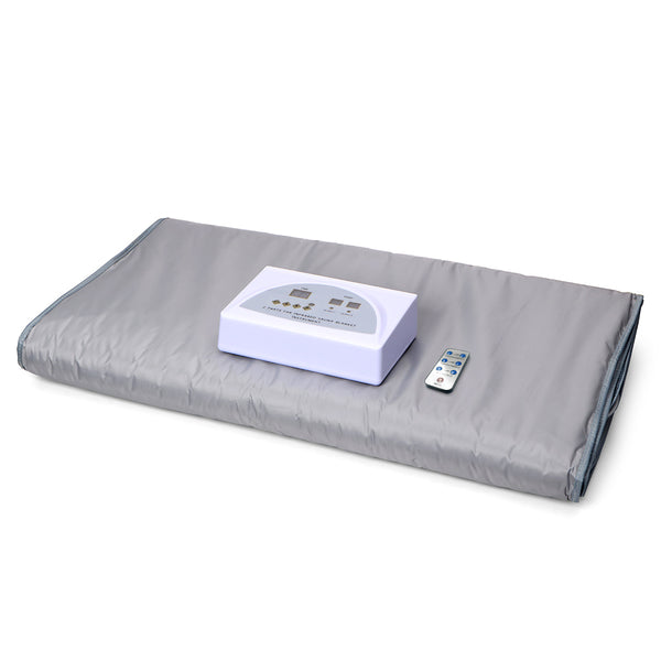 Gray heating pad with a control unit and remote on a white background