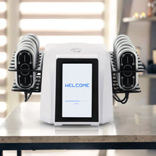 White electronic device with a screen displaying 'WELCOME' on a table.