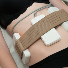 Medical device on a person's abdomen with a brown strap
