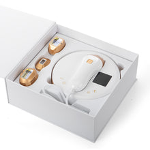 White electronic device with gold components in a white box on a white background