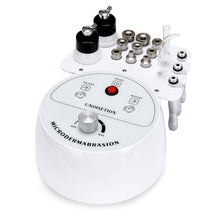 White microdermabrasion device with various attachments on a white background