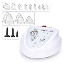 White vacuum therapy machine with a dial gauge and control knobs, shown with multiple clear glass cup attachments and three black nozzle tips on a white background.